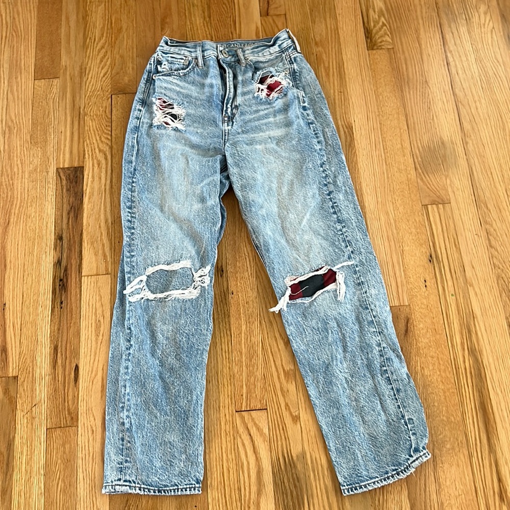 American Eagle women’s jeans size 2 ripped with red flannel and jean patches.